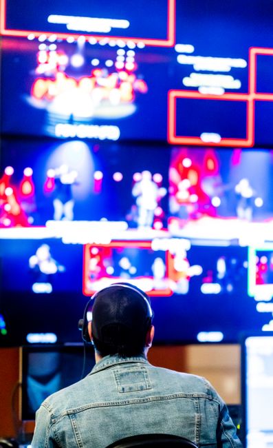 Techniker überwacht Livestreams auf mehreren Monitoren